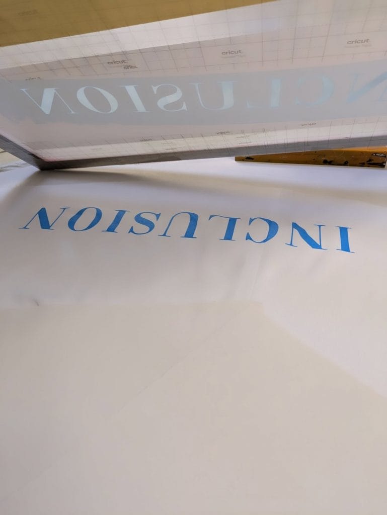 Lenzing Cape by Mary Jennings with the screen printed word "Inclusion"